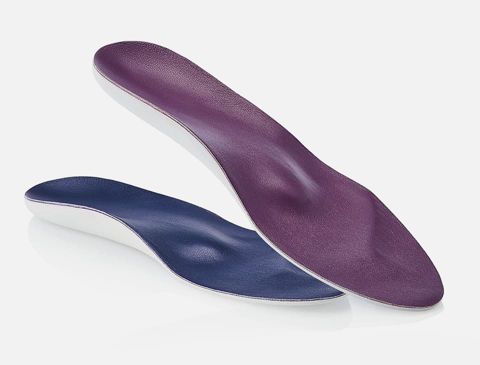 Two shoe insoles, one purple and one blue, with a contoured design, displayed against a white background.